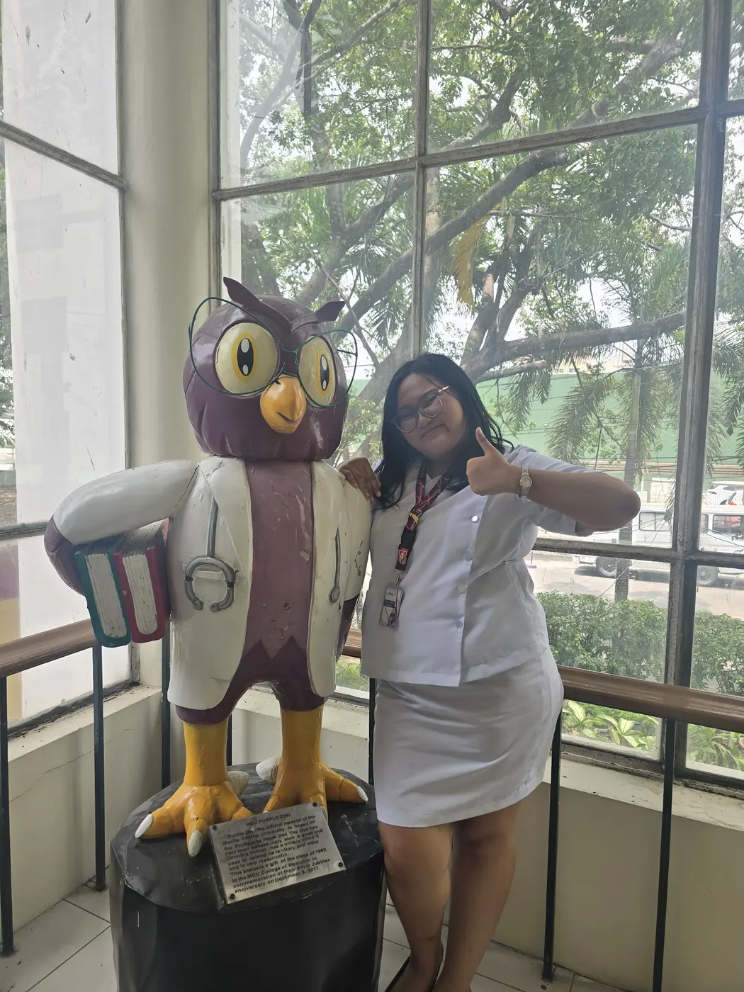 Sophia beside the Centro Escolar University healthcare owl
