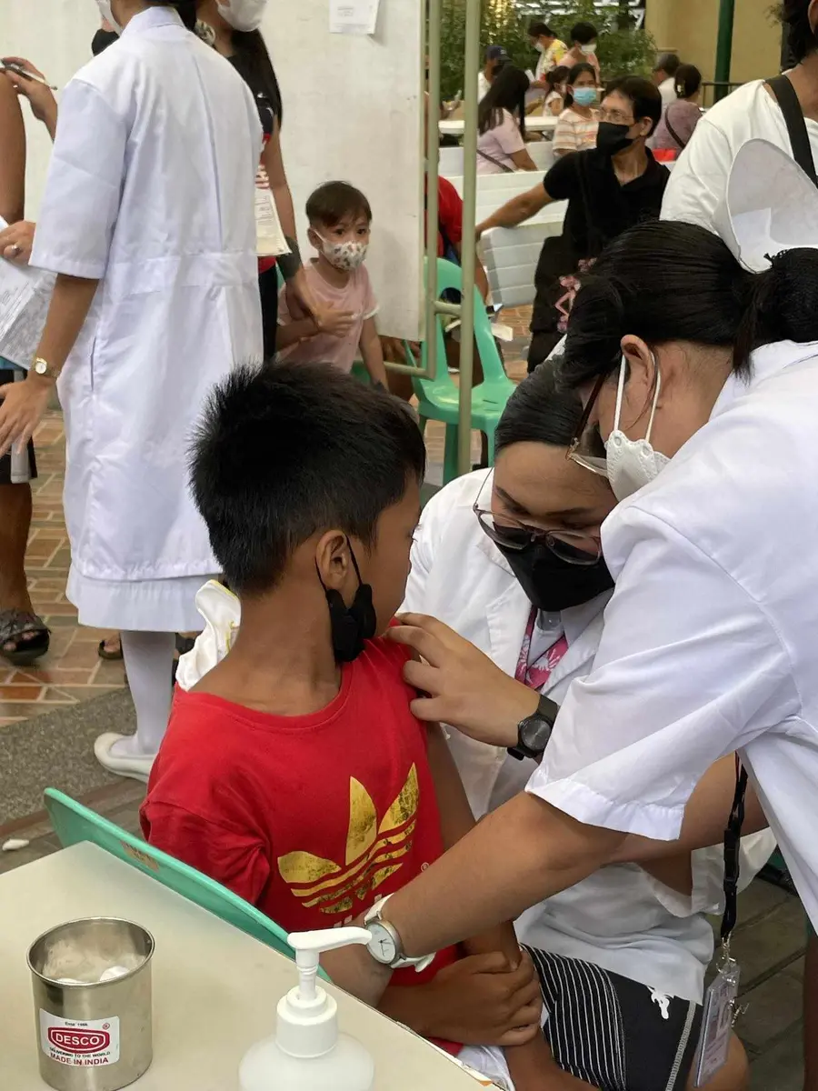 Sophia caring for a child during a community health activity